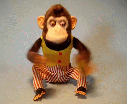 a toy monkey clapping cymbals